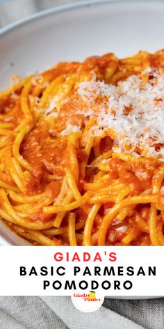 a white plate topped with pasta covered in sauce and parmesan cheese on top