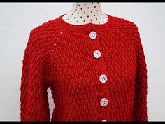 a woman's red sweater with buttons on it