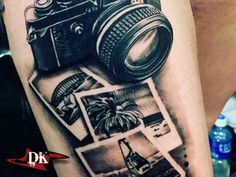 a black and white photo camera tattoo on the arm