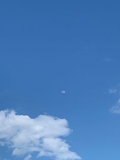 an airplane flying high in the sky with clouds