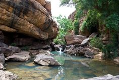 there is a small stream in the middle of some rocks