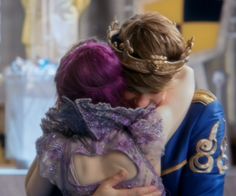 a couple of people that are hugging in front of each other with purple hair and blue clothes