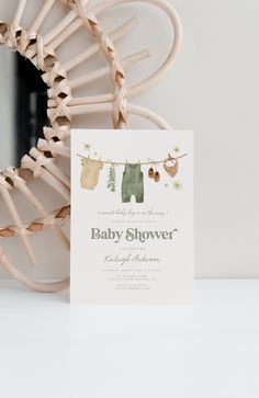 a baby shower is hanging on the clothesline and it's birth announcement card