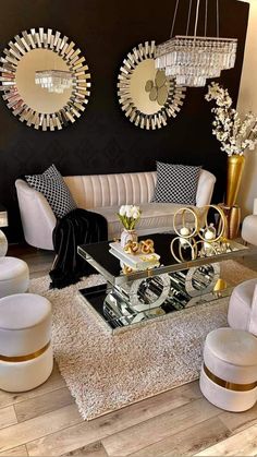 a living room filled with lots of furniture and mirrors on the wall above it's coffee table