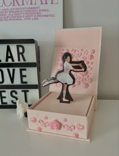 a card with a ballerina on it and some buttons in the box next to it