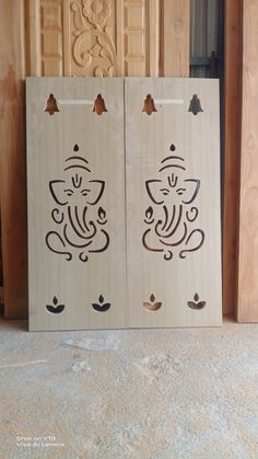 two wooden doors with designs on them