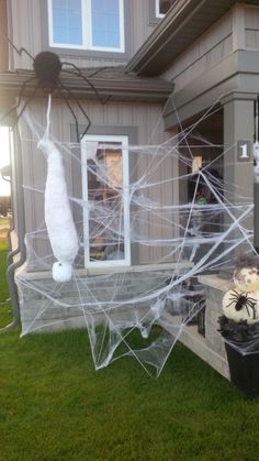 a house decorated for halloween with spider webs