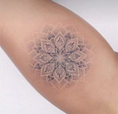 a woman's arm with a tattoo on it that has a flower design in the middle