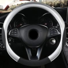 the interior of a car with steering wheel cover