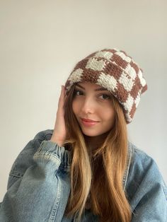 a woman wearing a brown and white knitted hat