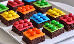 there are many small pieces of brownies with candy on them in the shape of people