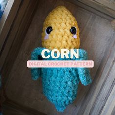 a crocheted corn stuffed animal with the words corn on it's chest