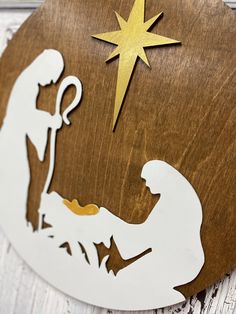 a nativity scene with the birth of jesus and star of david on a wooden plaque