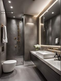 a modern bathroom with two sinks and a large mirror on the wall over the toilet