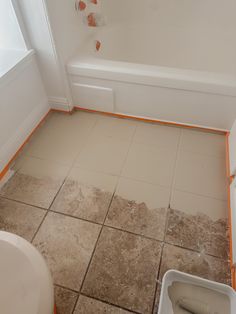 a bathroom that is being remodeled with tile on the floor and in the bathtub