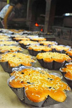 several muffins are lined up on a table in a bakery, ready to be baked