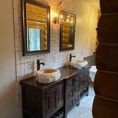 a bathroom with two sinks and mirrors in the wall next to each other on top of a counter