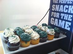 cupcakes on a tray with the perfect snack for the game sign in the background