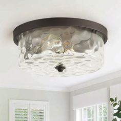 a ceiling light in a room with white walls