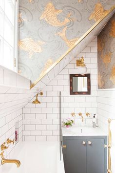 the bathroom is decorated in gold and white