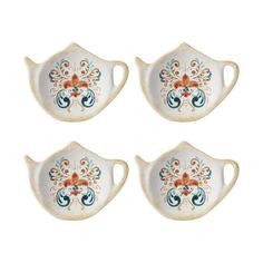 four pieces of white porcelain with floral designs