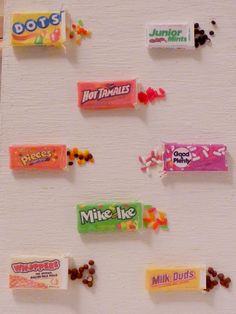 candy bar magnets are hanging on the wall in front of a white background with lots of different flavors