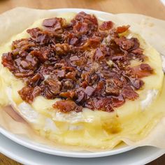 a white plate topped with food on top of a wooden table