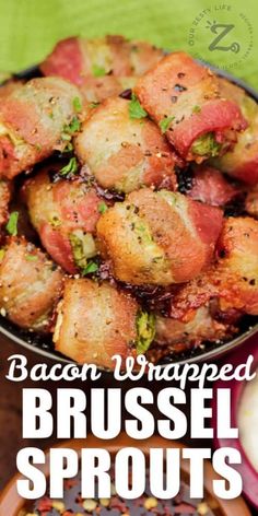 bacon wrapped brussel sprouts in a pan on a table with other dishes