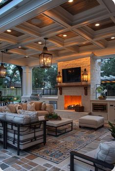 an outdoor living area with couches and fireplace