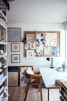 a room filled with lots of books and pictures on the wall