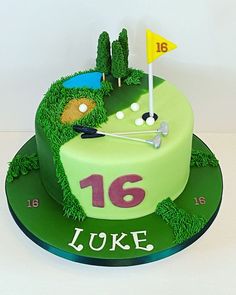 a birthday cake with a golf theme on the top and green grass around it that says 16 luke