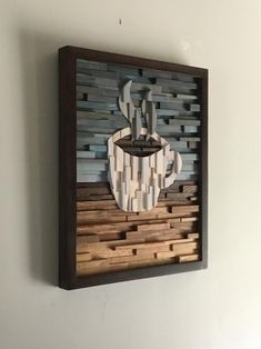 a piece of art made out of wood with a coffee cup on it's side