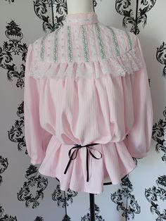 This lovely late Victorian/ early Edwardian style blouse is made from soft pink cotton-poly fabric trimmed with three kinds of lace, two kinds of ribbon, and tiny glass beads for a bit of sparkle. Size medium, fitting a 15" neck but loose at bust and waist, it is designed to puff out in the front when belted or tucked in, reflecting the style of 1890 - 1910. French seams, much hand stitching on trim and finishing, hooks and eyes at back and wrists. 3/4 sleeves are also decorated, gently gathered at shoulder and cuff. Black ribbon not included, just used to show belted look. Also looks good with modern clothing. Edwardian Blouse, Edwardian Style, Gibson Girl, French Seam, Edwardian Fashion, Style Blouse, Linen Trousers, Women's Costumes, Black Ribbon