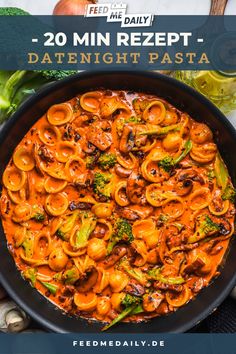 a pan filled with pasta and broccoli on top of a table