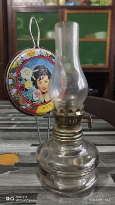 an antique oil lamp sitting on top of a wooden table