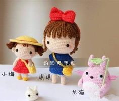 three small crocheted dolls are standing next to each other on a white surface