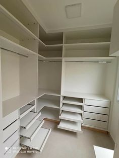 an empty walk in closet with shelves and drawers