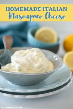 homemade italian mascarpone cheese in a bowl with lemons and spoons behind it