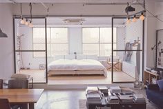 an open living room and bedroom area with sliding glass doors