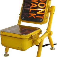 a yellow chair with a sign that says walk on the back and an orange light above it