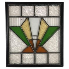 a stained glass window with green, orange and white designs