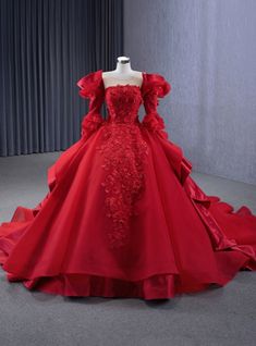 a red wedding dress on display in a room