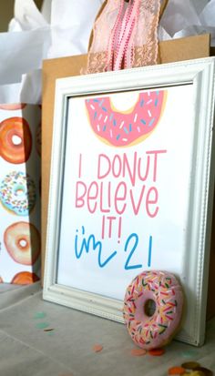 a donut is sitting next to a sign that says i donut believe it's in 2 1