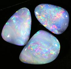 three white opal stones sitting next to each other