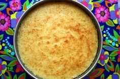 a pan filled with food on top of a colorful table cloth