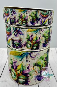 three tins with different designs on them