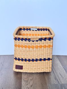 a woven basket sitting on top of a wooden floor