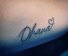 the word ohana written in cursive writing on someone's arm