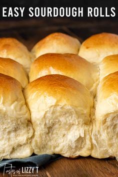 a close up of some bread rolls on a wooden table with the words easy sourdough rolls