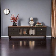 a living room with wood floors and gray walls